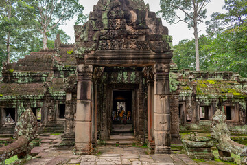 Stone entrance to temple ruin building pagoda architecture of Banteay Srei in Angkor Wat complex historical site in Seim Reap Cambodia on a cloudy overcast day