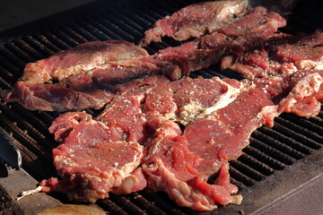 Beefsteak on the grill with coarse salt on it