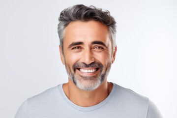 Portrait of handsome mature man. Handsome mature man looking at camera and smiling while standing against grey background
