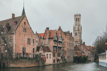 Fototapeta na wymiar Beautiful city skyline of the village building architecture along a river rozenhoedkaai Rosary Quay canal reflection in Brugge Flanders Belgium on a cloudy day