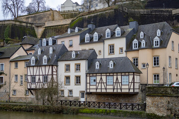 Colorful pink, yellow, and grey buildings in the old town village along a walled cliff of Luxembourg City Europe