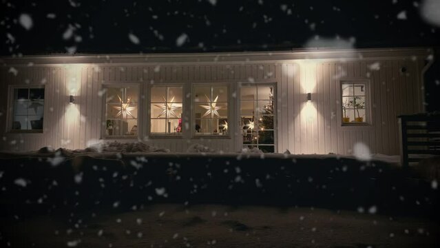 Beautiful Christmas Scene, Family Decorate Tree Inside House, Snow Falls Outside