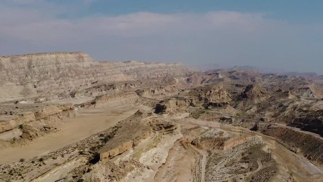 panorama view of wind erosion formation landform coastal desert climate dry mud rocky mountain in background high altitude in Hormuz island dragon beach in Iran natural landscape Qatar border marine