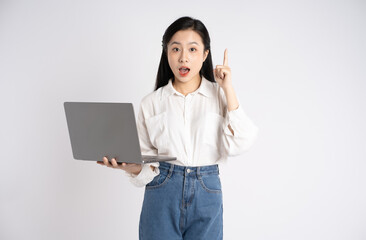 Portrait of young Asian businesswoman using laptop on white background