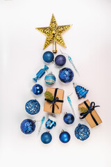 New Year tree made of gifts and New Year's balls. Christmas decor. Gold star, blue balls. New Year tree made of  balls.