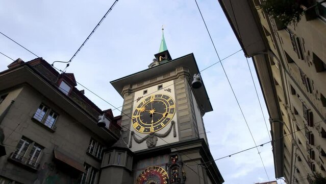 Historic astronomical clock tower with dial in Bern city center.