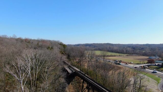 Aerial Shot of Railroad Tracks Winding Out of a Forest and on to the Pope Lick Trestle in Louisville Kentucky