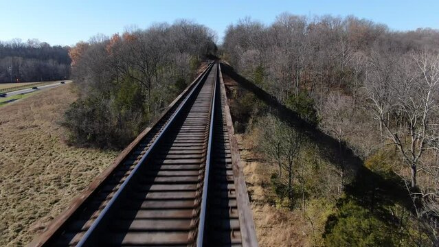 Aerial Shot Pushing Forward Over the Tracks of the Pope Lick Railroad Trestle in Louisville Kentucky on a Sunny Winter Day