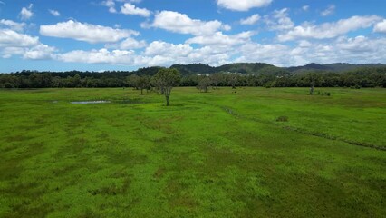 Forward moving aerial over Mudgeeraba Creek and green space, Gold Coast, Queensland, Australia