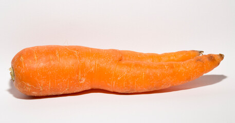 Crooked carrot is a mutant. Vegetable on a white background.