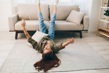 Calm and Cosy: A Happy Woman Relaxing on a Modern Sofa in Her Comfortable Apartment