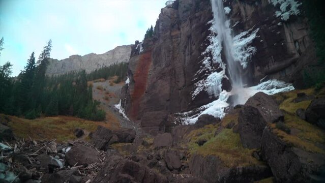 Telluride Colorado sunset stream Bridal Veil Falls frozen ice Waterfall fall autumn cool shaded Rocky Mountains Silverton Ouray Millon Dollar Highway afternoon historic town landscape slow pan up