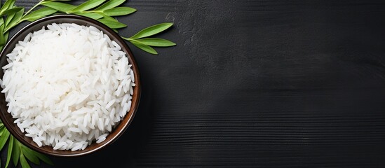Raw rice in bowl with leaf copy space background
