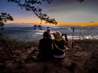 Silhouette Tourists waiting for sunrise at Pha Nok Aen in the morning in Phu Kradueng National Park, Loei, Thailand