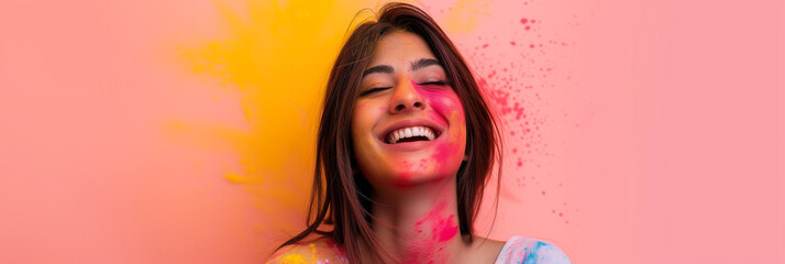 Joyful young woman with colorful powder on her face celebrating Holi, Festival of Colors, background with a place for text