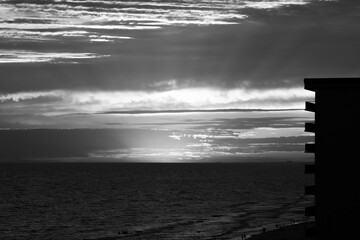 black and white sunset on the beach with rays of light - Powered by Adobe