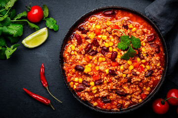 Chili con carne, mexican dish with minced beef, red beans, paprika, corn, cilantro and red peppers...