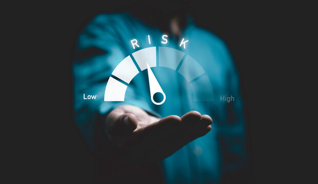 Businessman holding Risk level indicator rating since low to high for Risk management and assessment review concept.