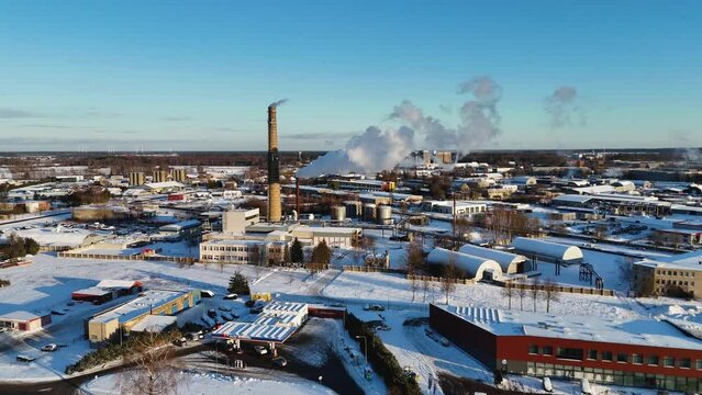Cinematic drone shot of industrial landscape, Steam coming out of chimney, Silute, Lithuania