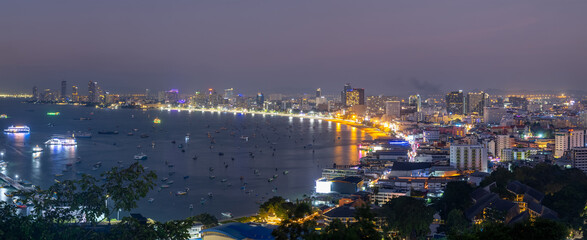 Naklejka premium Panoramic view of Pattaya cityscape and Sea during twilight, the eighth-largest city in Thailand.