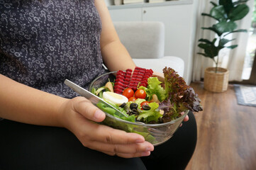 Asian Overweight woman dieting Weight loss eating fresh fresh homemade salad healthy eating concept Obese Woman with weight diet lifestyle. - obrazy, fototapety, plakaty