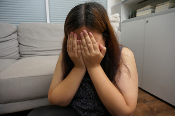 Sad Young woman. Young woman at home living room sofa feeling sad tired.Young woman depressed emotion panic attacks.