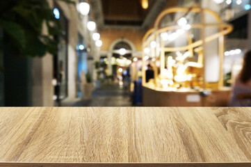 Empty dark wooden table in front of abstract blurred boken bankground of restaurant. Can used for display or montage your products. Mock up for space.