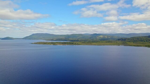 Ascending flyover of Huillinco Lake on a sunny day, Chonchi, Chilo&eacute; Island, Chile
