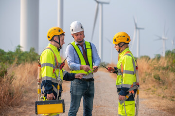 Engineer surveyor wearing uniform walking holding box inspection work in wind turbine farms...