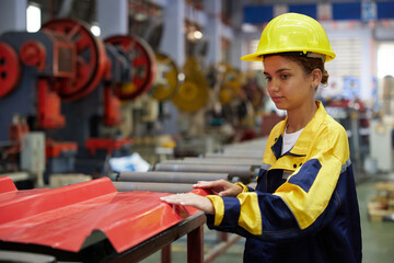 worker or technician checking quality metal sheet from machine in the factory