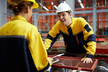 engineer or worker talking and meeting with coworker in the metal sheet factory