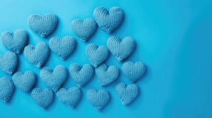 Blue knitted hearts on a blue background, top view, with space for text. Valentine's Day, hobbies, knitting, love, health concept.