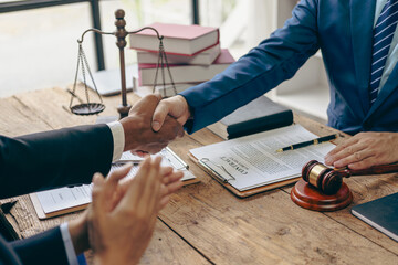 Handshaking legal consultant agreement, lawyer contract advising on litigation and handshaking contract as a lawyer to receive complaints from clients, lawyer, close-up image - obrazy, fototapety, plakaty
