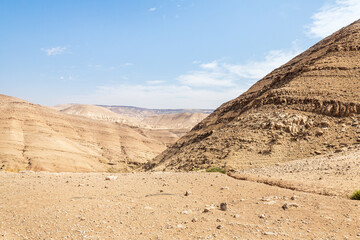 View of low mountains in gorge Wadi Al Ghuwayr or An Nakhil and wadi Al Dathneh from road leading to it near Amman in Jordan