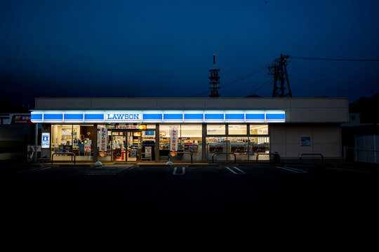 Nagano, Japan - 2 November 2023 : Front facade of a standalone Lawson convenience store with parking lot before sunrise at Nagano city, Japan