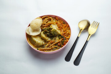 Lontong with curry soup accompanied by fried sweet potatoes chili sauce and noodles