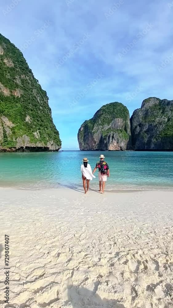 Wall mural a couple of men and woman visit Maya Bay Koh Phi Phi Thailand, Turquoise clear water Thailand Koh Pi Pi, Scenic aerial view of Koh Phi Phi Island in Thailand