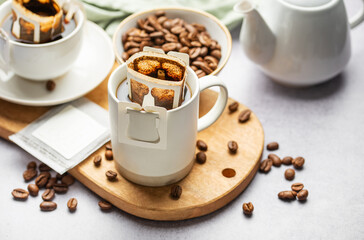 Drip coffee bag with ground coffee in  cup