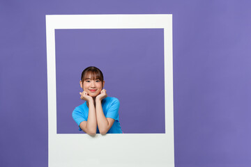 Smiling lady take photo of herself posing on camera isolated on purple background