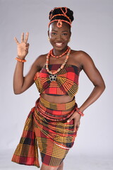 Young black African Nigerian igbo looking gorgeous wearing native attire holding three fingers up