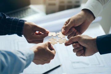 Engineer Teamwork Concept, Worker team hands join puzzle pieces in the office. Joining for cooperation success business of engineering partnership agreement of Architect engineer contractor. teamwork. - obrazy, fototapety, plakaty