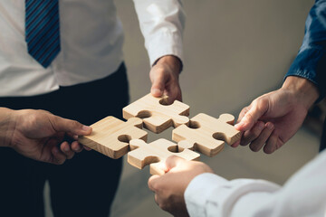 Concept of teamwork and partnership. Business hands join puzzle pieces in the office. business people putting the Jigsaw team together. Charity, volunteer. Unity, team business. business idea.CSR.ESG