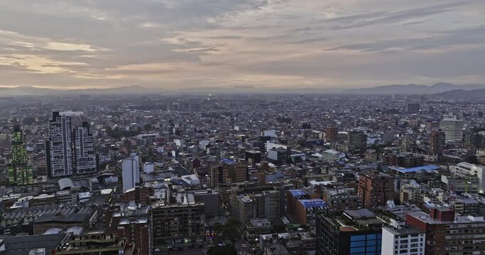 Bogota Colombia Aerial v12 panoramic views drone flyover La Salle and San Luis neighborhoods capturing beautiful cityscape with sun setting on the city skyline - Shot with Mavic 3 Cine - November 2022