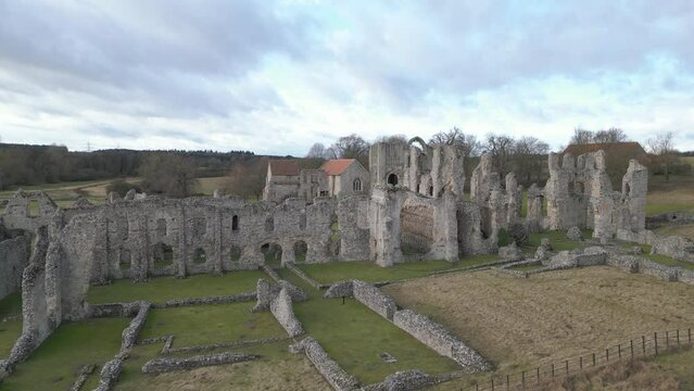 Castle acre priory ruins in norfolk, clouds adorn the sky, aerial view