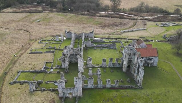 Castle acre priory ruins in southern park, norwich, with green fields, aerial view