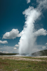 Old Faithful Geyser erupting during the day in Yellowstone National Park