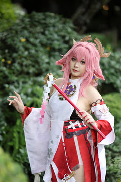 Portrait of a beautiful young woman game cosplay on japanese garden