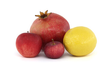 Pomegranate, apples and lemon isolated on white