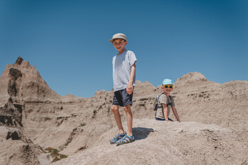 Two brothers smiling while exploring the rock formations of Badlands National Park