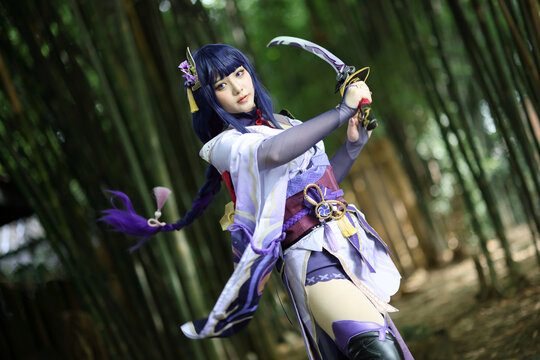 Portrait of a beautiful young woman game cosplay with samurai dress costume on Japanese garden